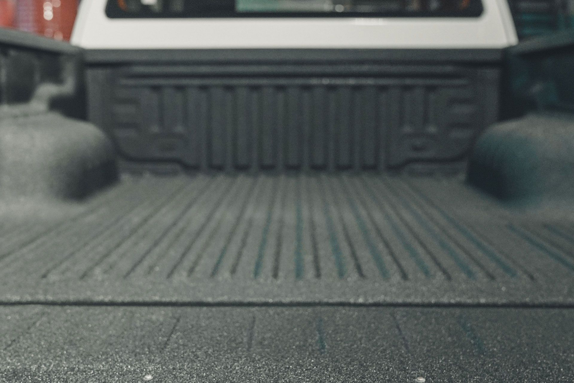 Sprayed-on bed liner in the back of a pickup truck