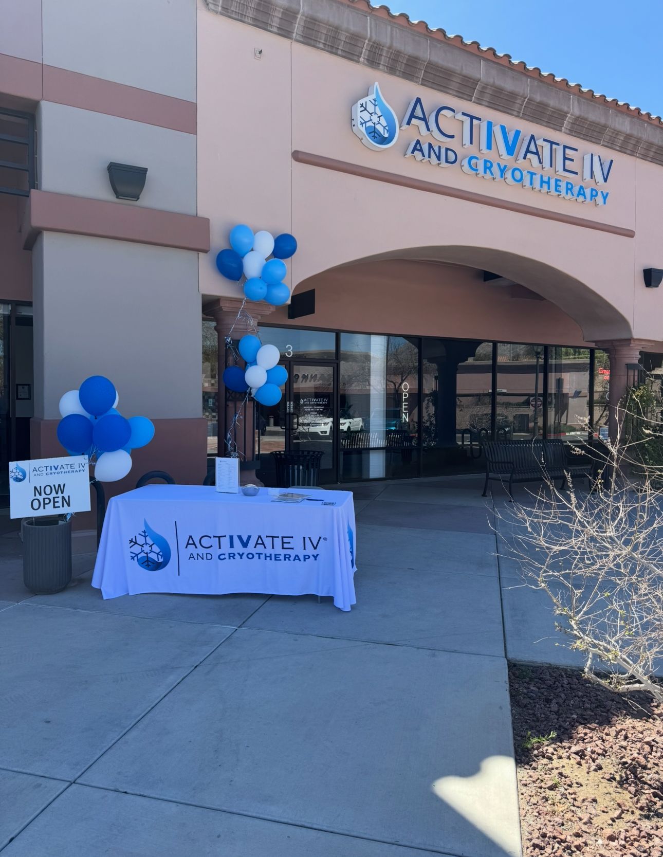 Exterior of Activate IV and Cryotherapy with balloons and a table promoting its services.