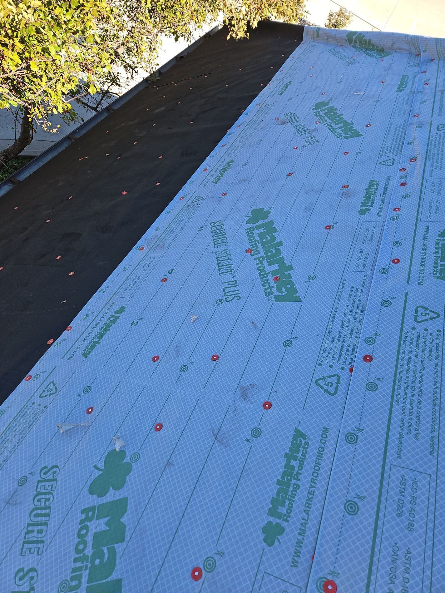 A partially covered roof with underlayment in place, ready for shingles.