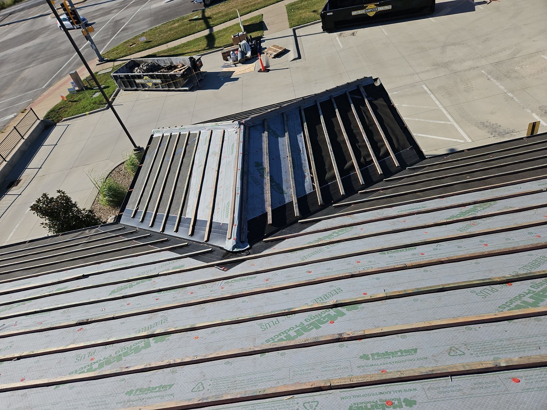 Metal roof with a raised, triangular section, likely a skylight.