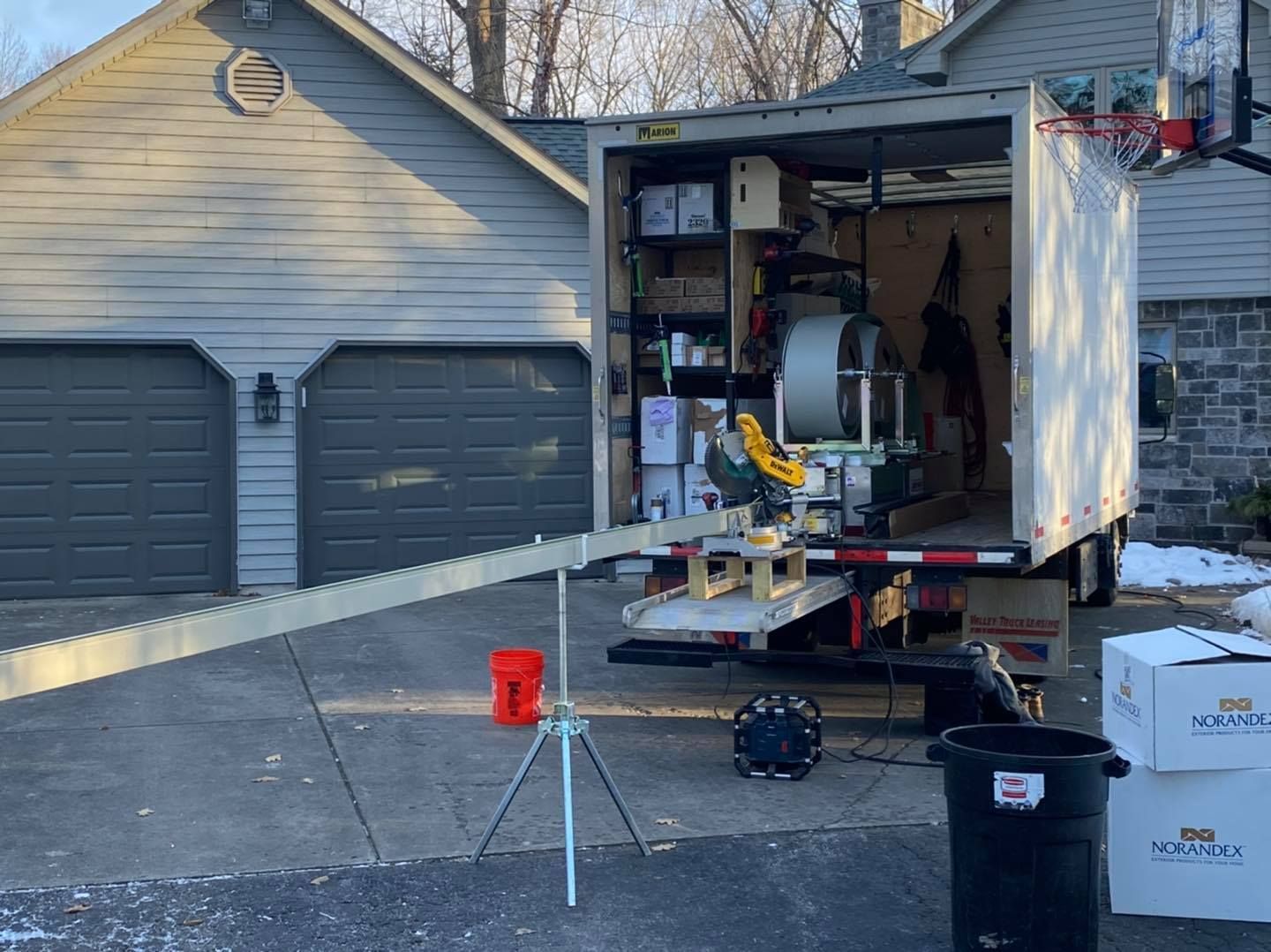 A white truck is parked in front of a house