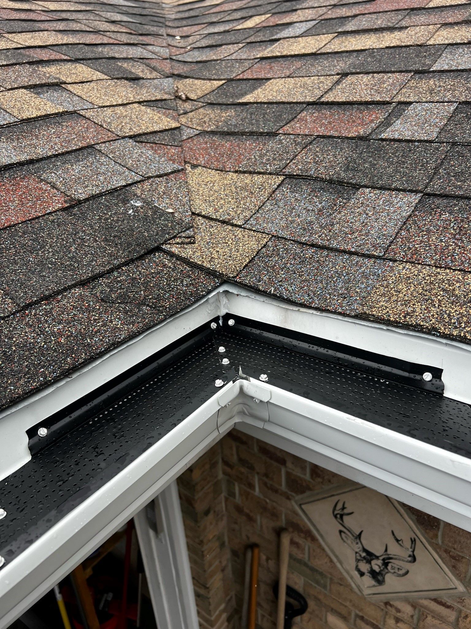 A close up of a gutter on the roof of a house.