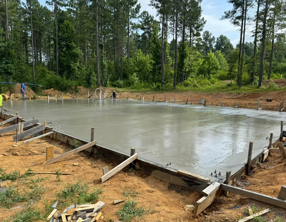 A concrete foundation is being built in the middle of a forest