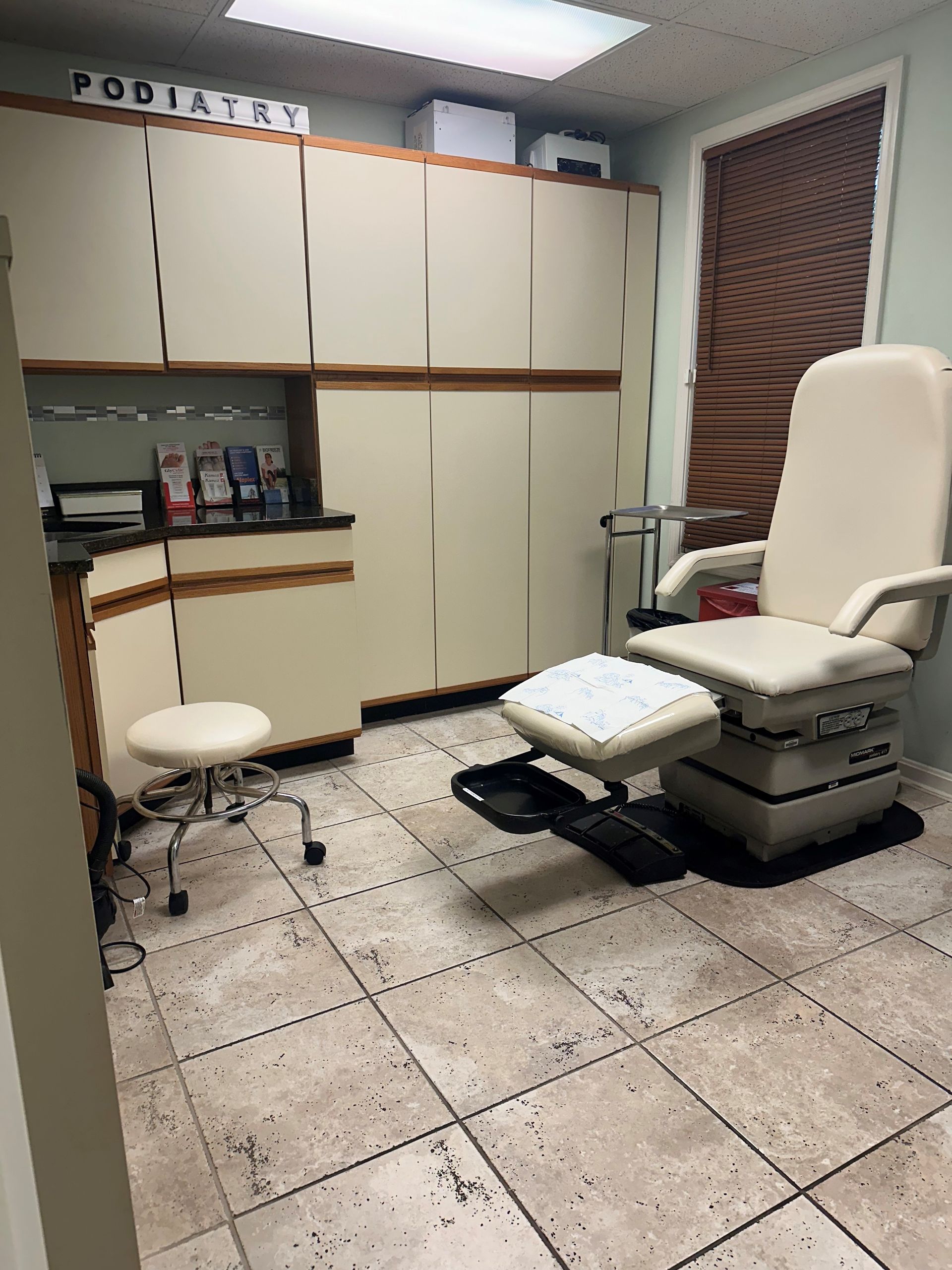 A room with a chair and a stool in it