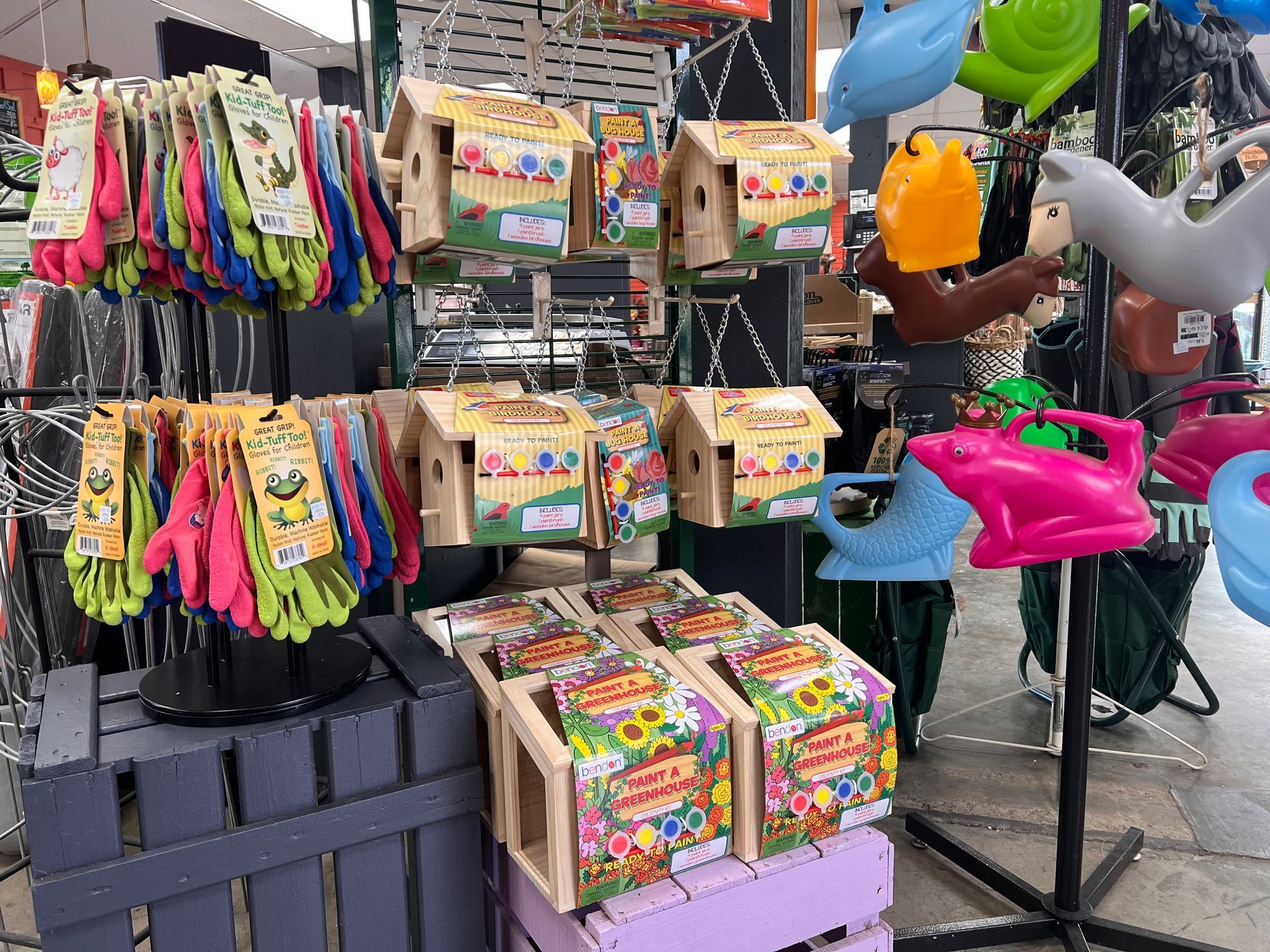 A display of gardening supplies including bird houses and watering cans