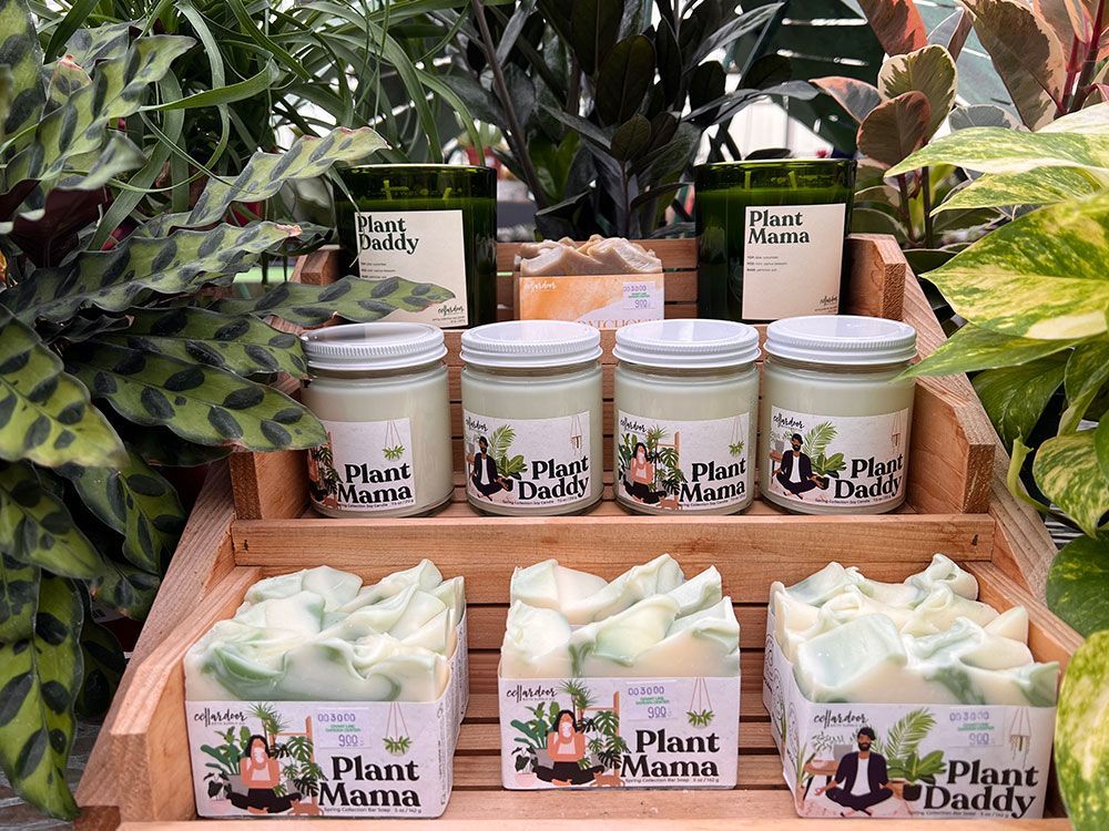 A display of candles and soaps on a wooden shelf.