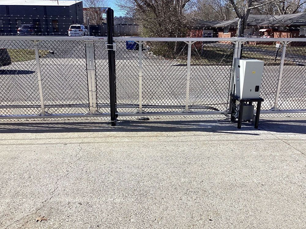 Chain link fence with an automatic gate opener.