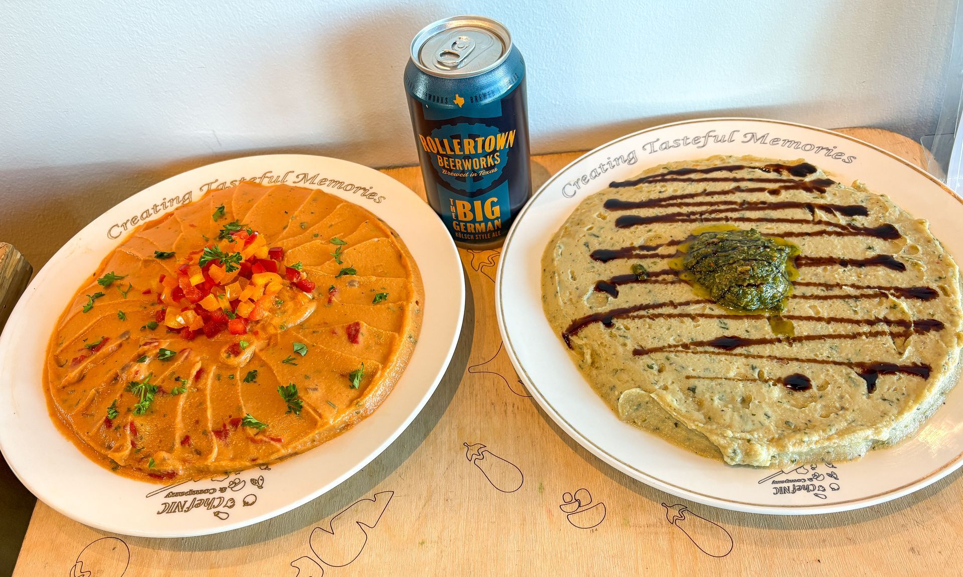 Two large, round hummus plates.