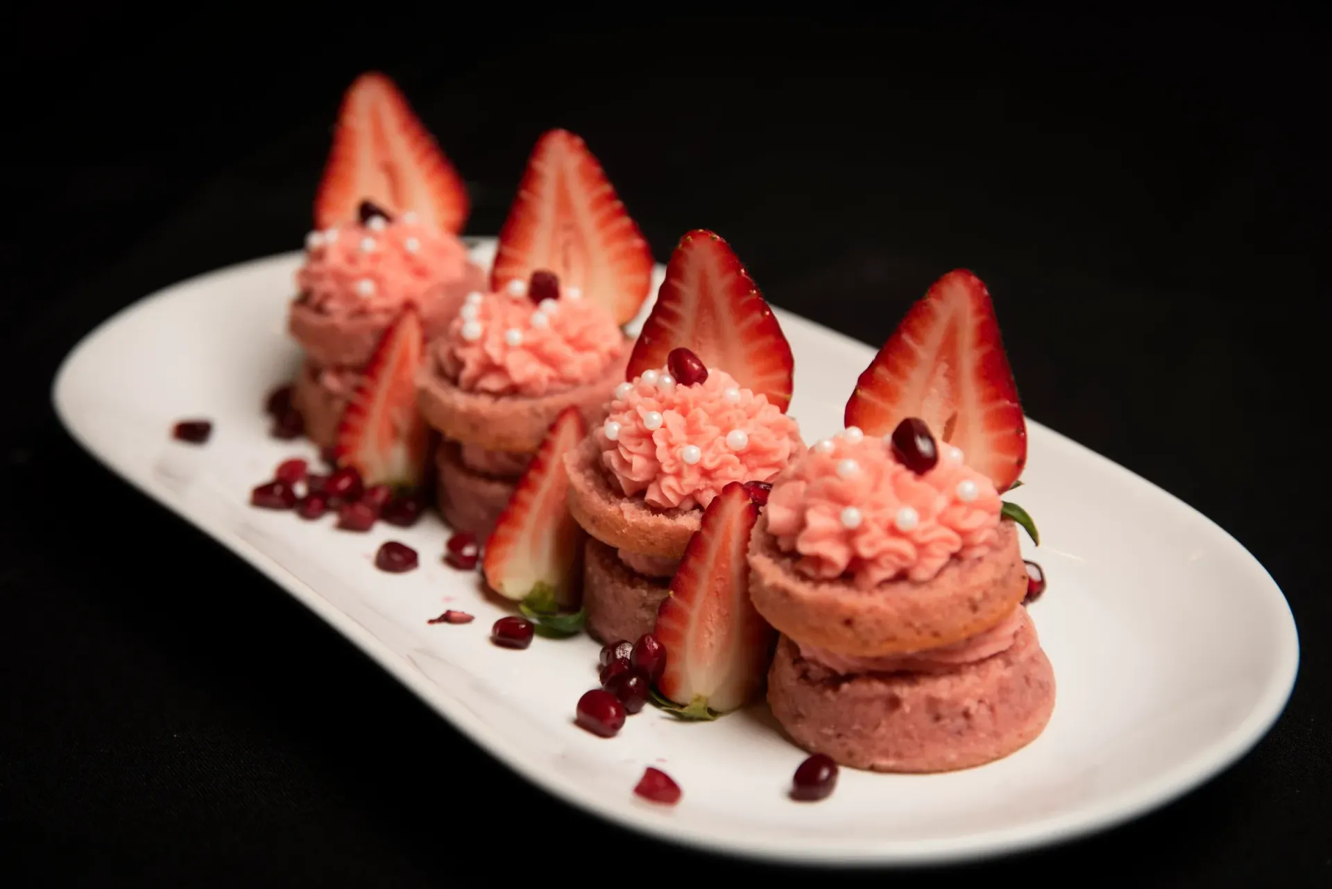 Strawberry desserts on a white plate.