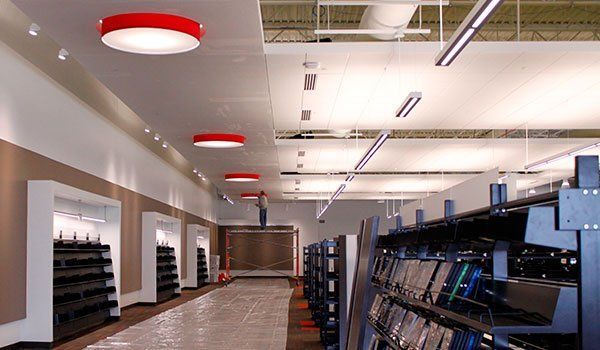A long hallway in a store with a lot of shelves