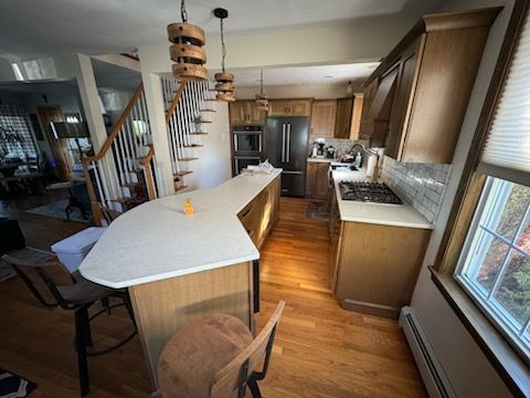 A kitchen with wooden cabinets and a white counter top