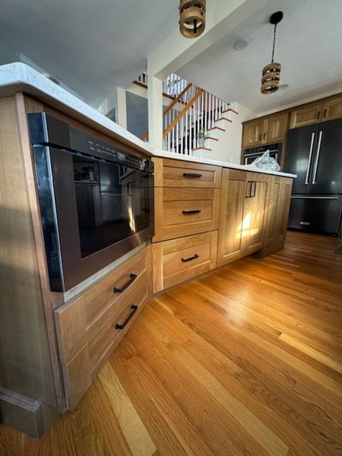 A kitchen with wooden cabinets and stainless steel appliances