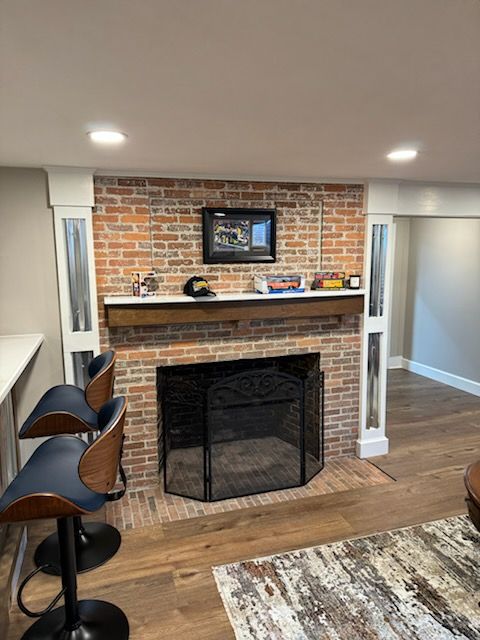 There is a fireplace in the middle of the room