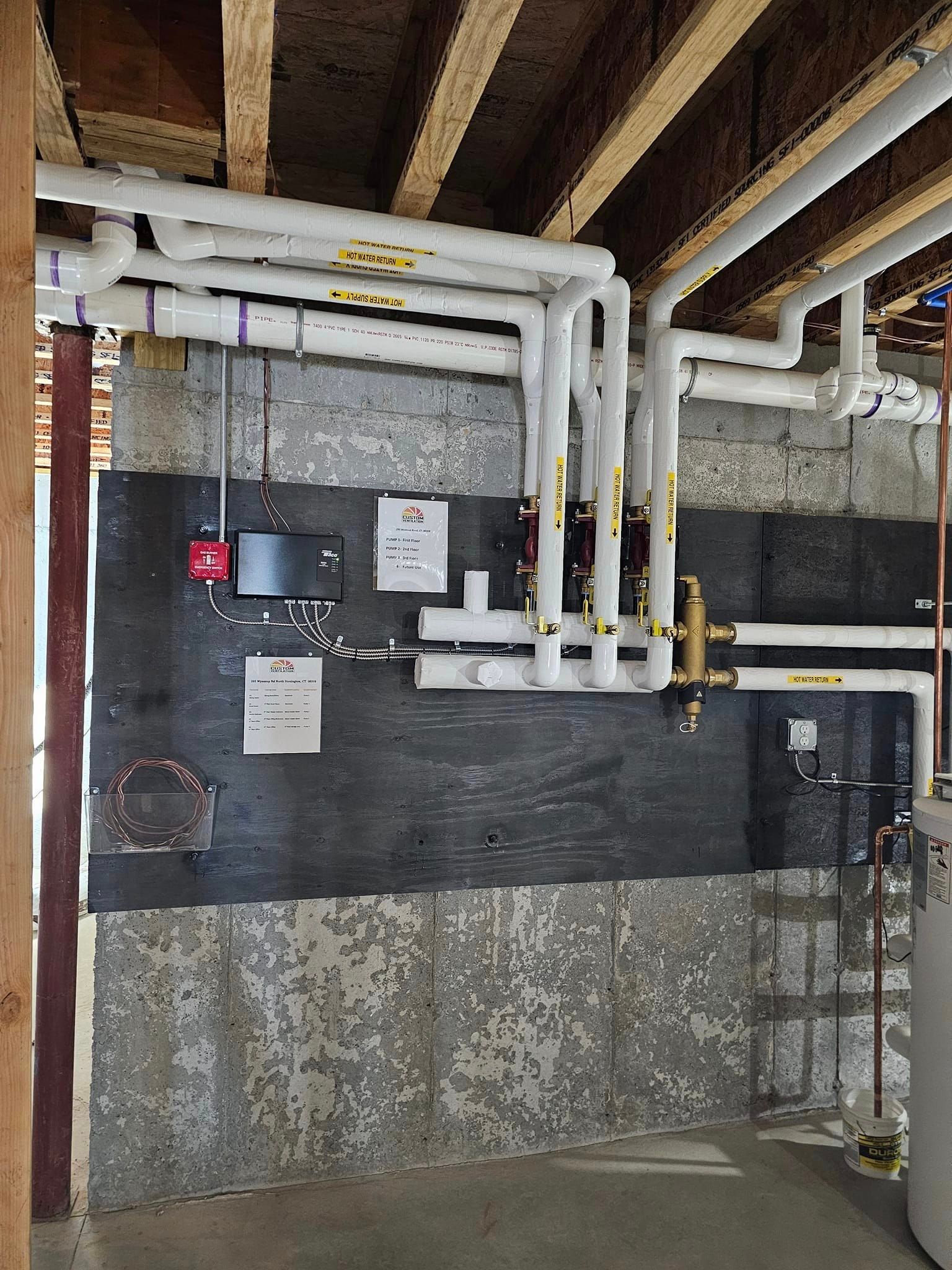 A room with a lot of pipes hanging from the ceiling