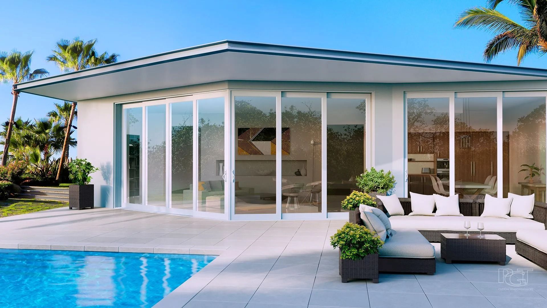 Modern house with pool, patio, and large glass doors. Exterior with outdoor furniture, palm trees, and blue sky.