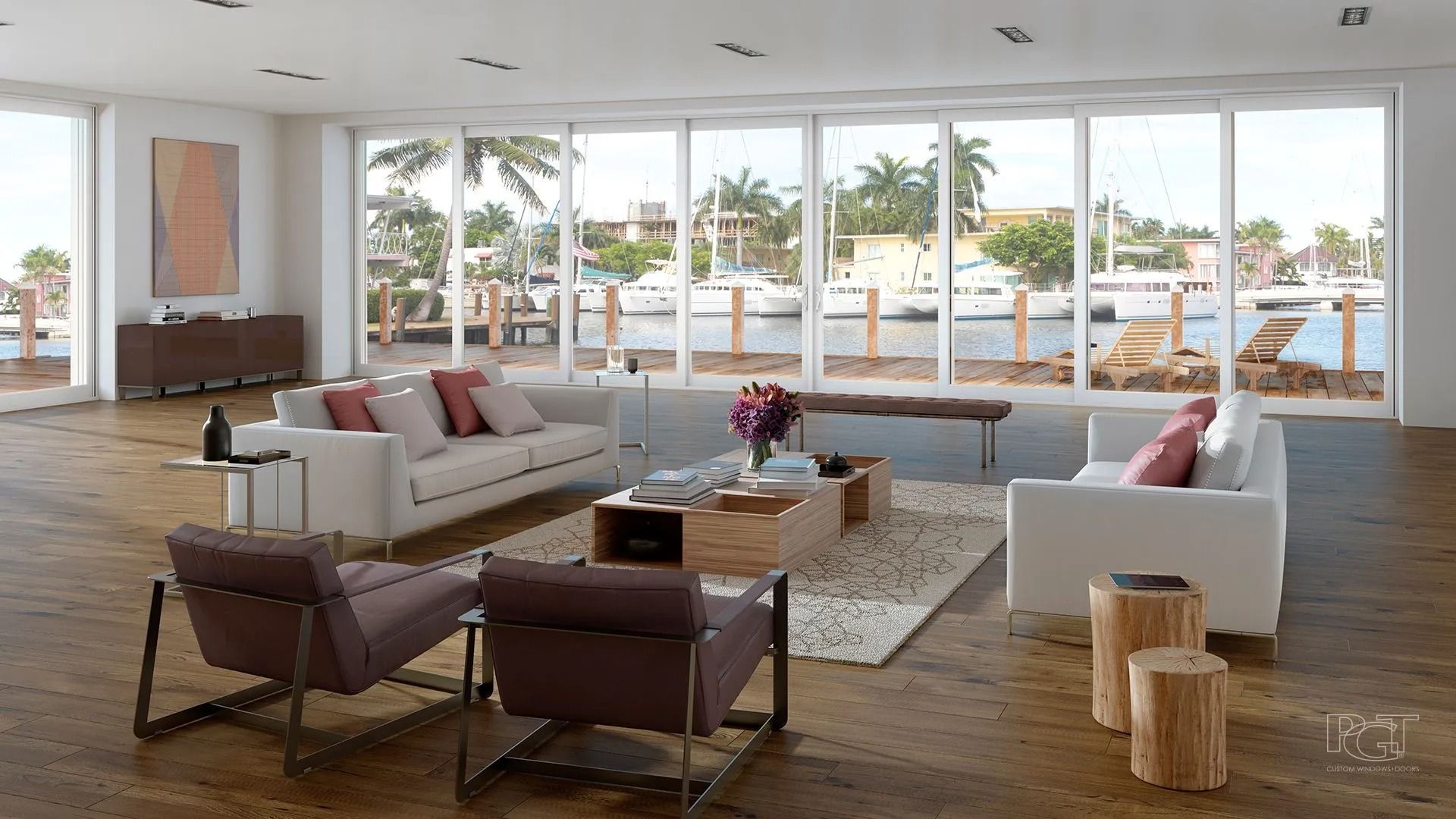 Modern living room with large windows overlooking a waterway, neutral tones, white sofas, wood flooring.