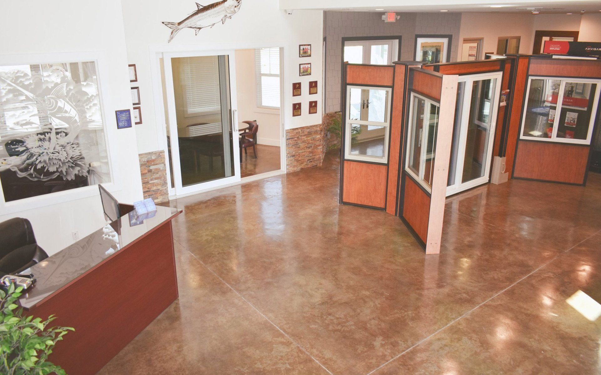 Front entrance with steps and double doors, address 201 above the doors, and fish art.