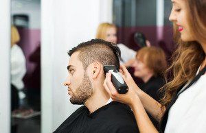 Man getting a haircut at a salon.
