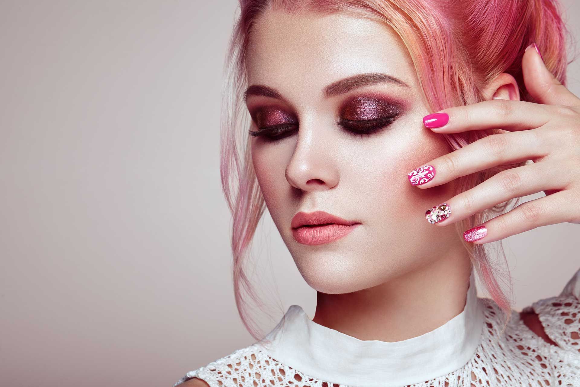 woman with pink hair and matching makeup, with beautiful nails