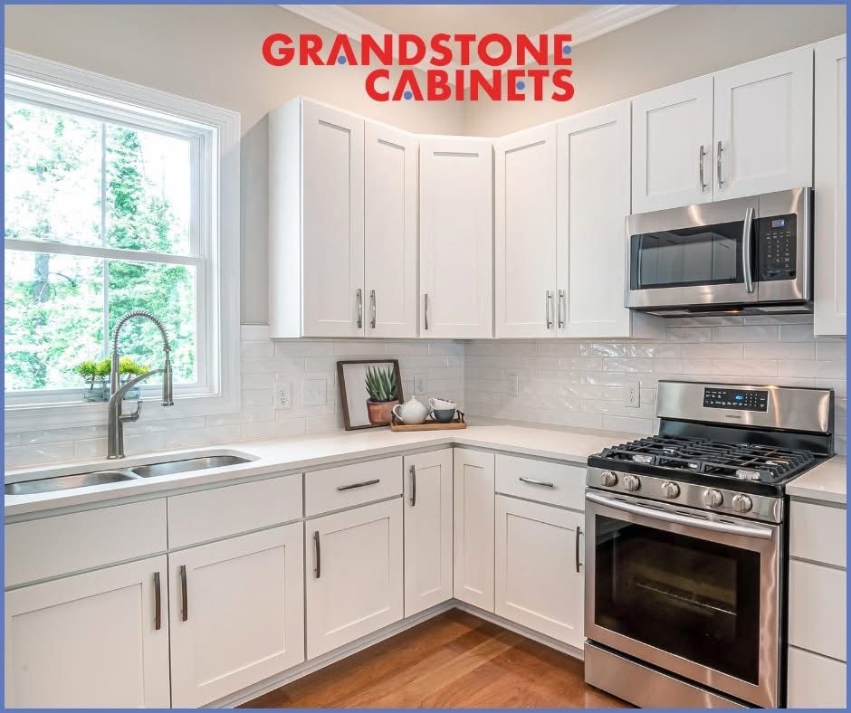 White kitchen with white cabinets, stainless steel appliances, and white countertops.