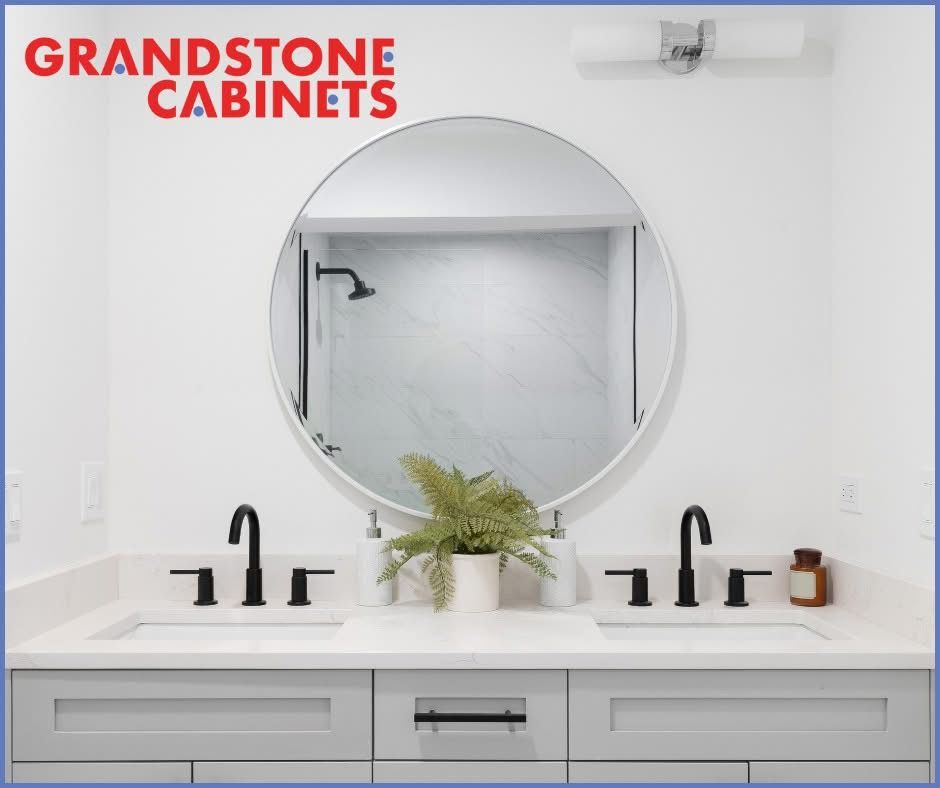 Modern bathroom vanity with a round mirror and black fixtures.