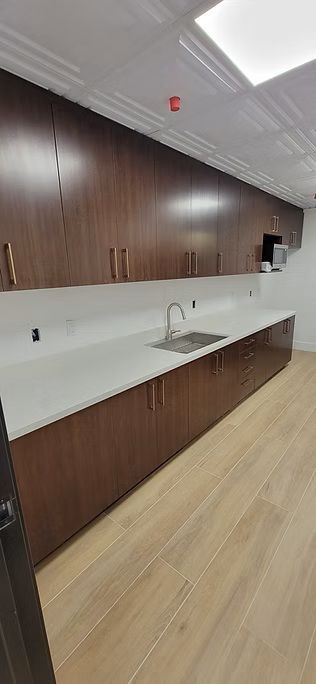 A restaurant with tables and chairs and a tree in the middle