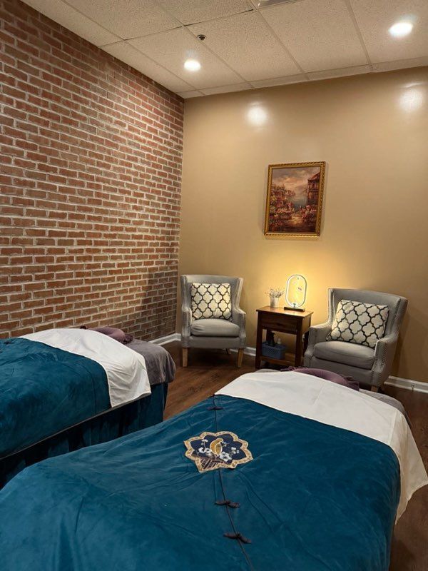 There are two beds and two chairs in the room.