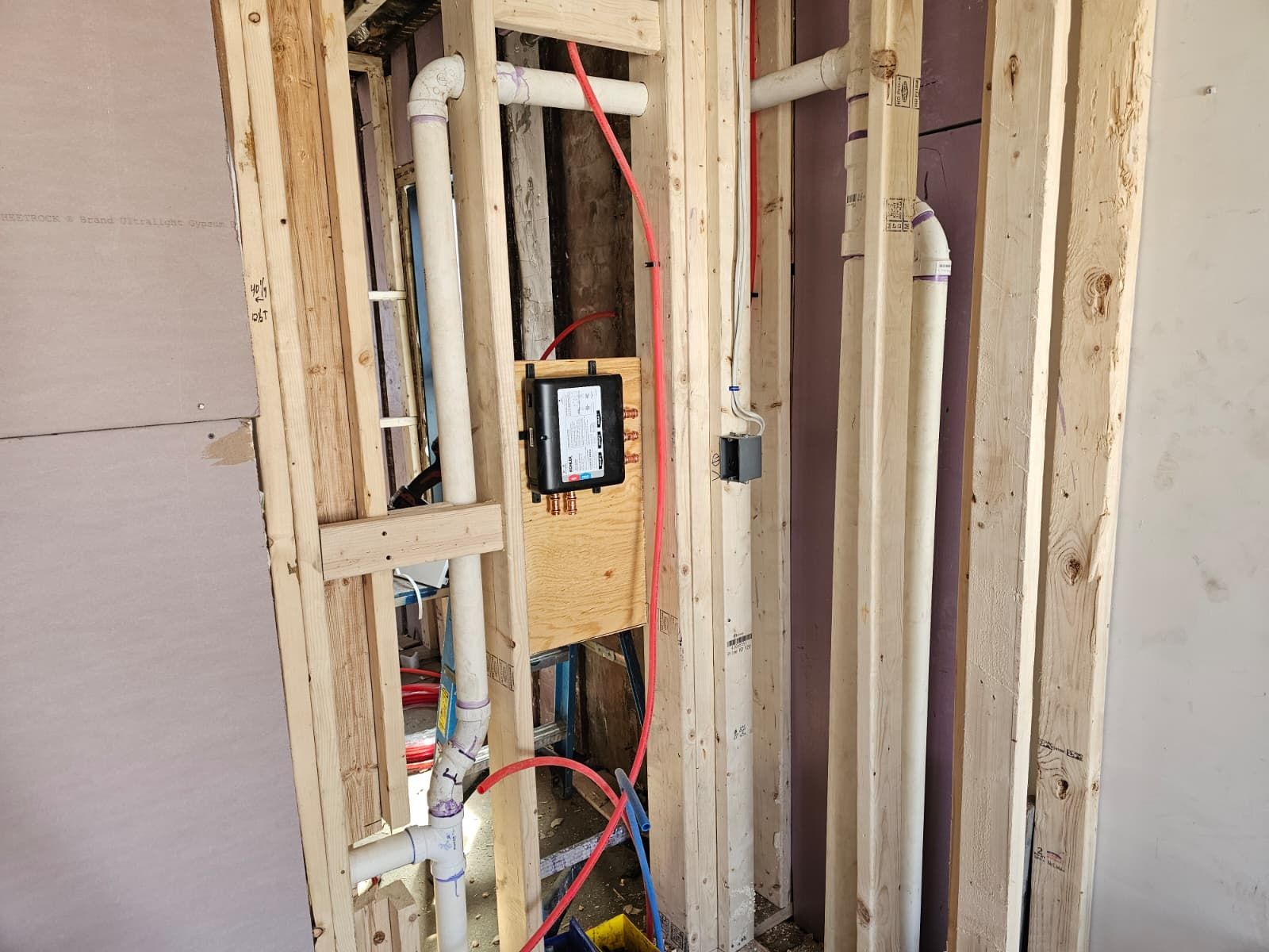 Exposed wall framing with electrical wiring and a junction box during home renovation