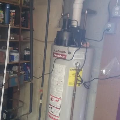 A.O. Smith ProMax water heater in a utility room with shelves and exposed pipes
