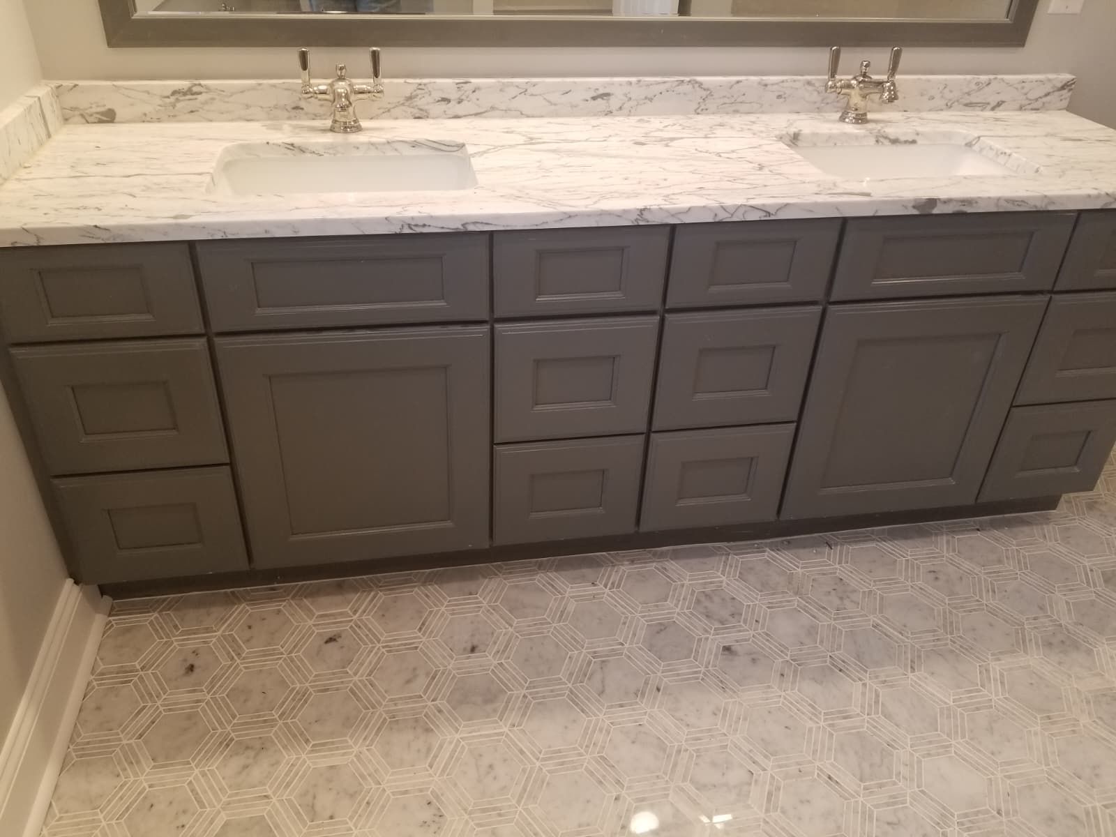 Modern bathroom vanity with gray cabinets, white quartz countertop, and twin sinks under a large mirror