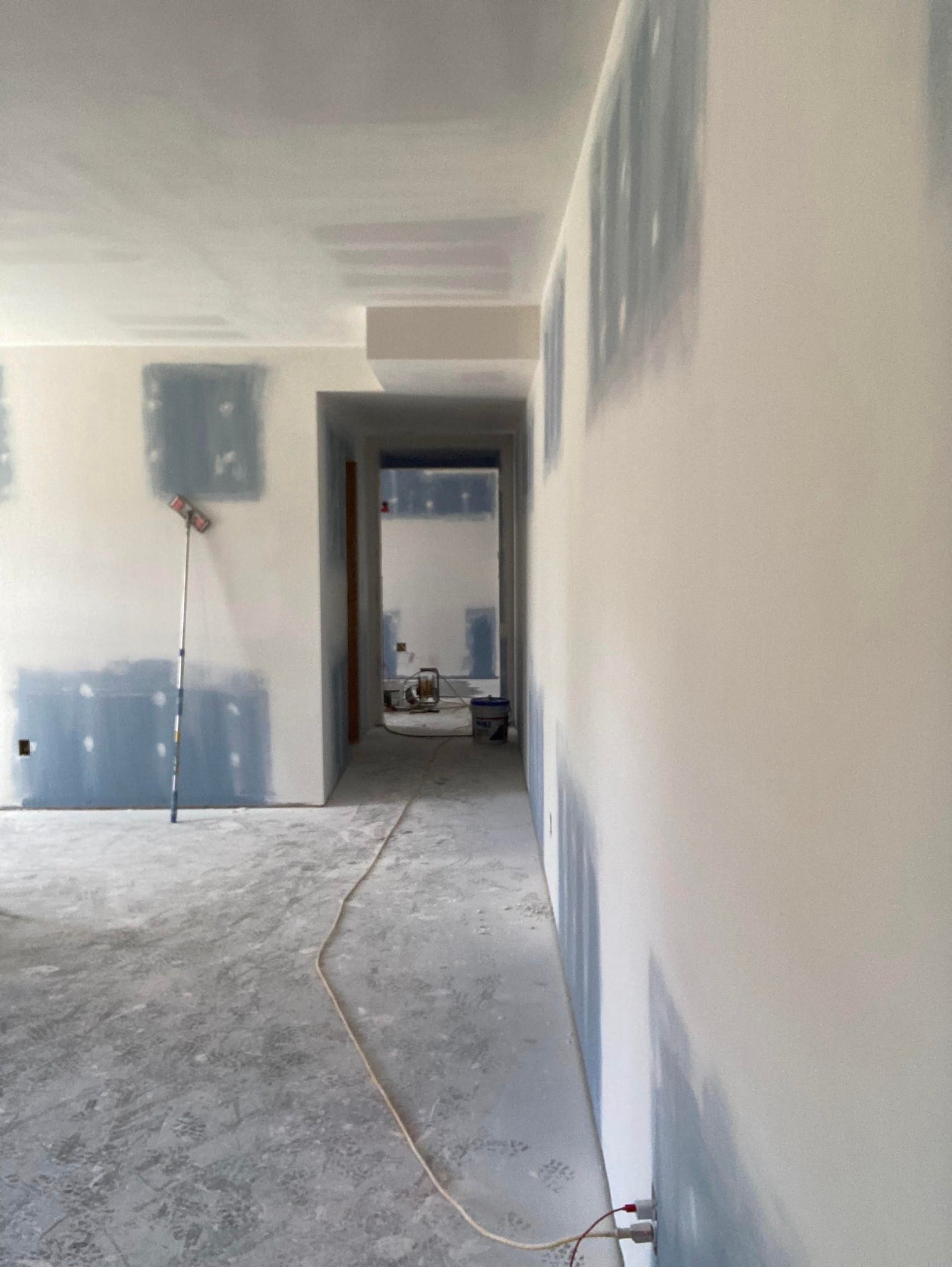 Interior view of a room under construction with drywall and unfinished walls.