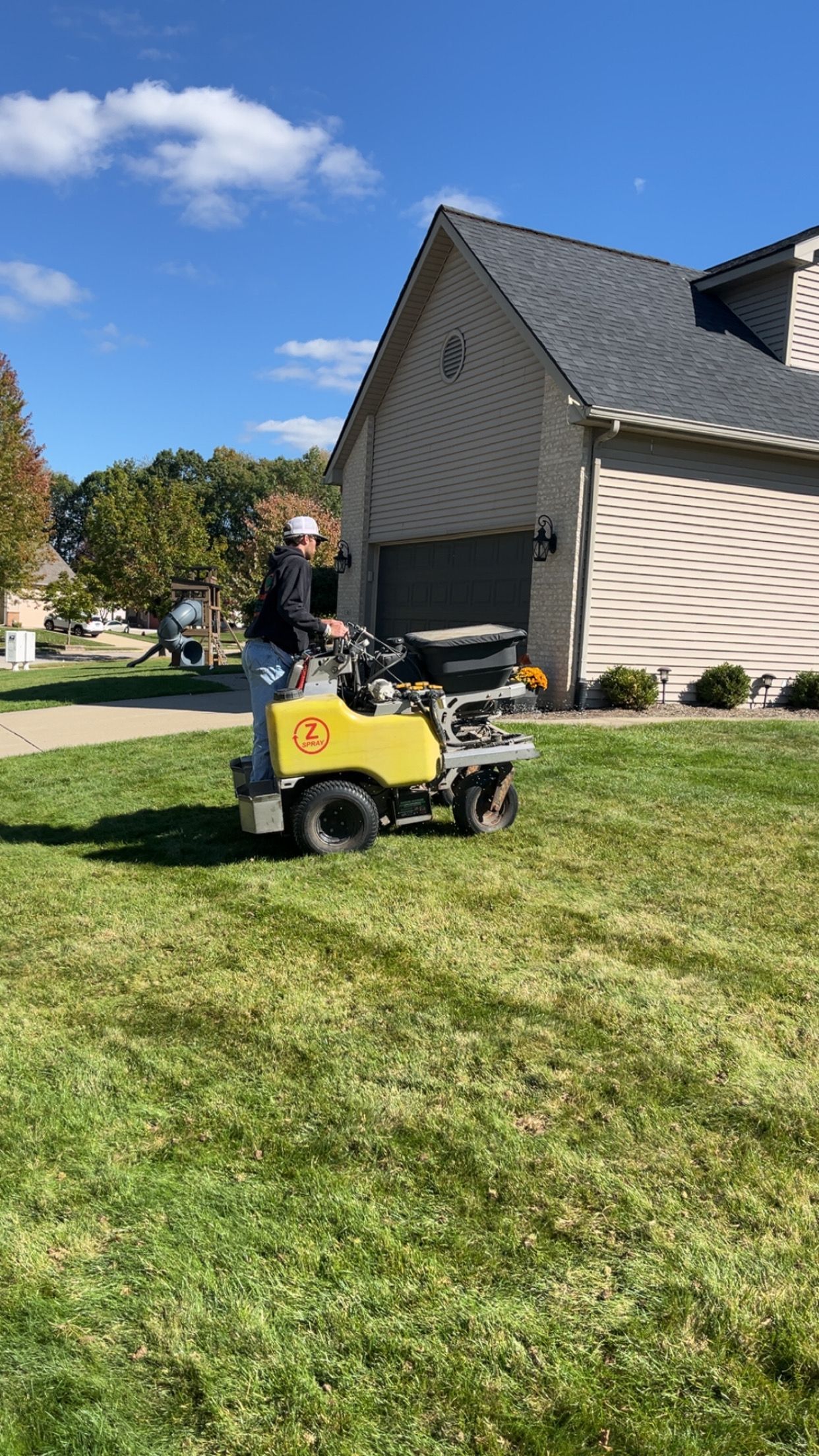 A rolled-up sod roll next to prepared soil and laid green turf.