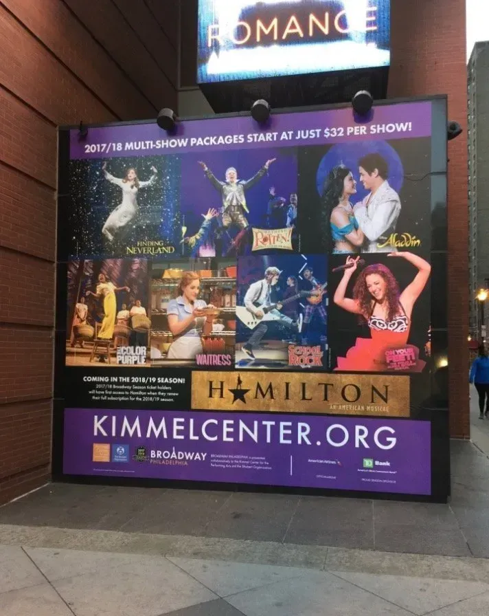 Theater poster for Hamilton at Kimmel Center, with musical scenes and purple border display.