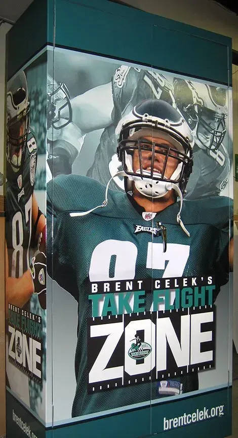 Brent Celek “Take Flight Zone” poster with Eagles player in green jersey and helmet