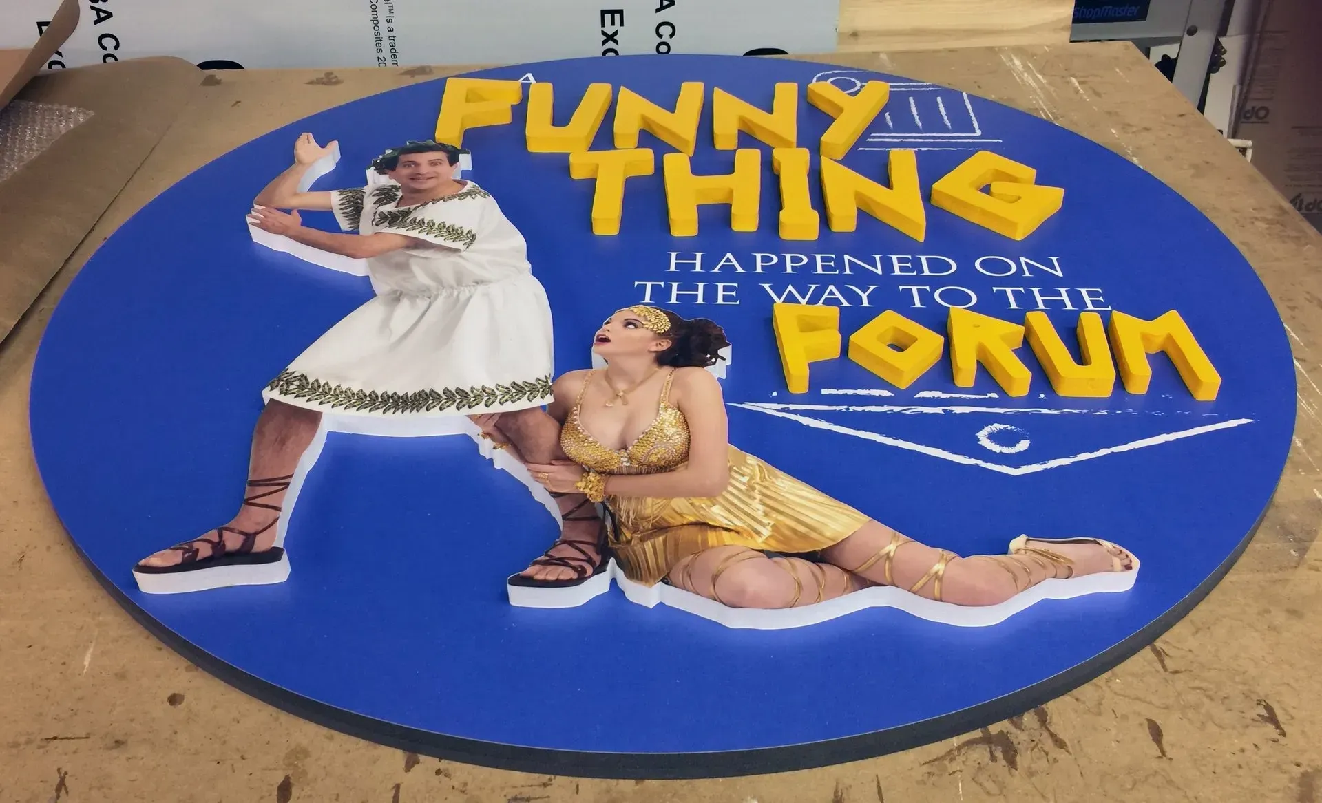 “Funny Thing” cardboard display with two circus-themed performers on a blue circular base