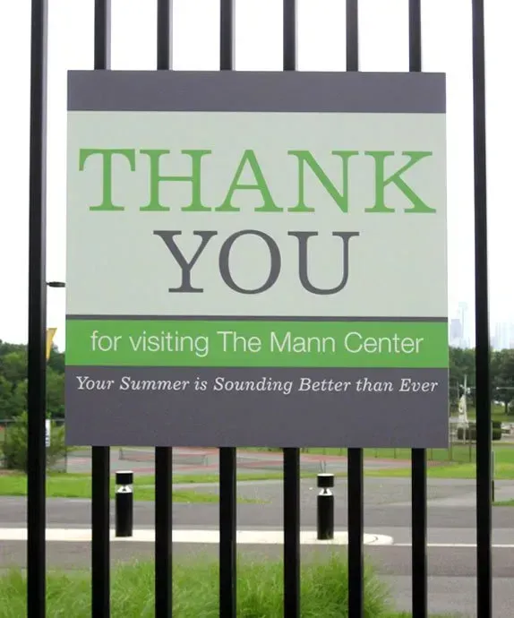 “Thank You” sign at The Mann Center with green accents behind black bars