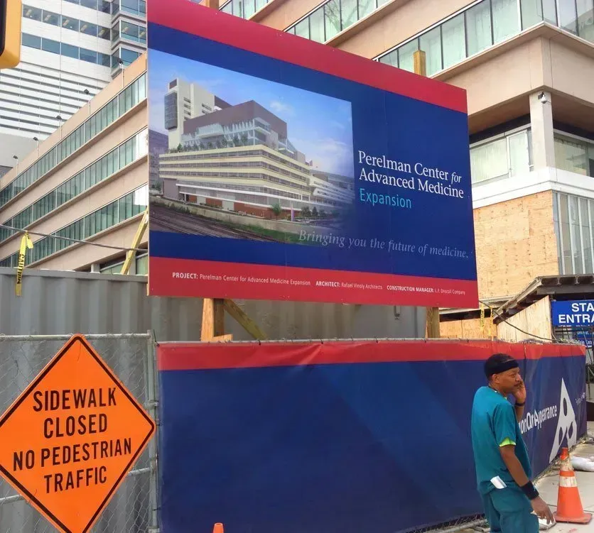 Construction site sign for Freedom Center for Addiction Services expansion, with sidewalk closed notice