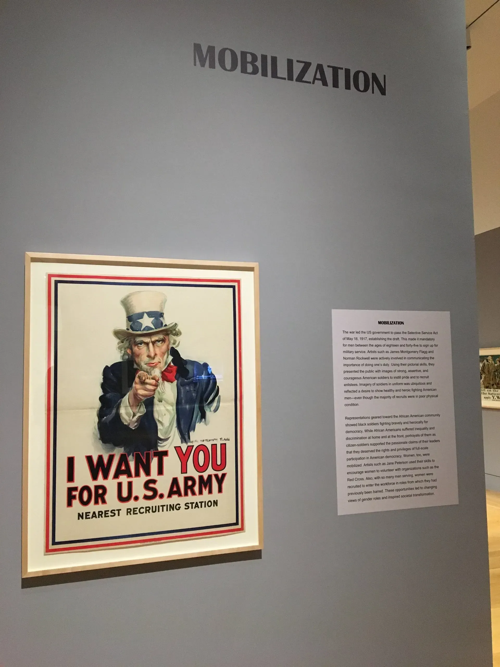 World War I recruitment poster of Uncle Sam beneath “MOBILIZATION” wall text, with caption panel beside it