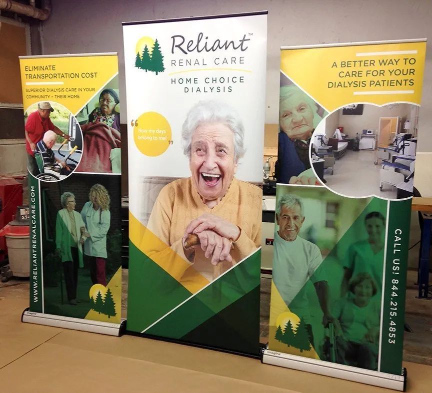 Reliant Renal Care banners at a booth, showing dialysis care photos and a smiling patient.