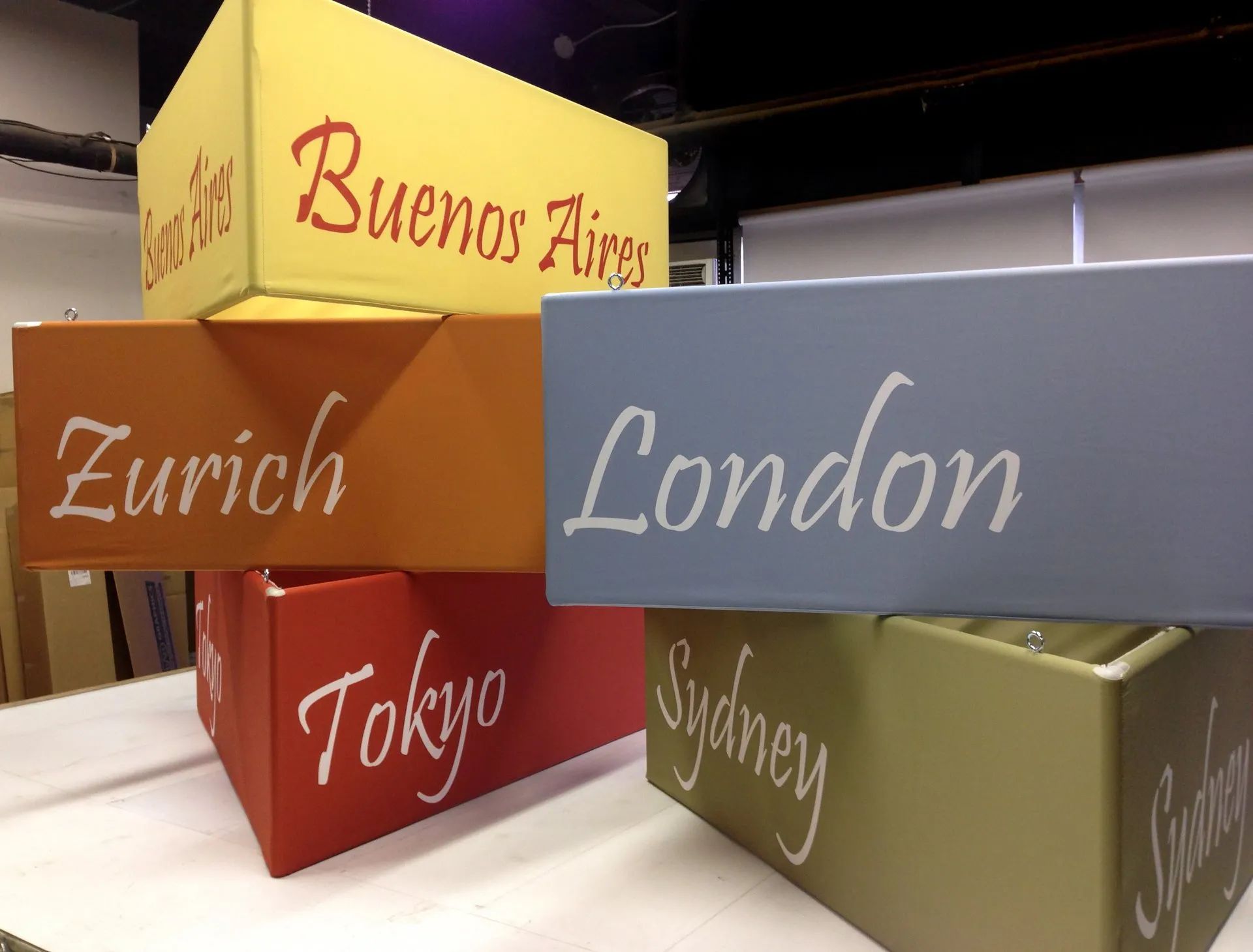 Colorful stacked blocks labeled Buenos Aires, Zurich, London, Tokyo, Sydney, and San Francisco