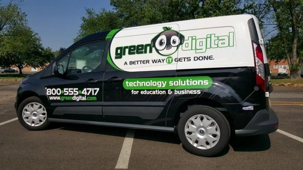 White Green Digital van with green logo and “technology solutions” parked outdoors on a sunny day