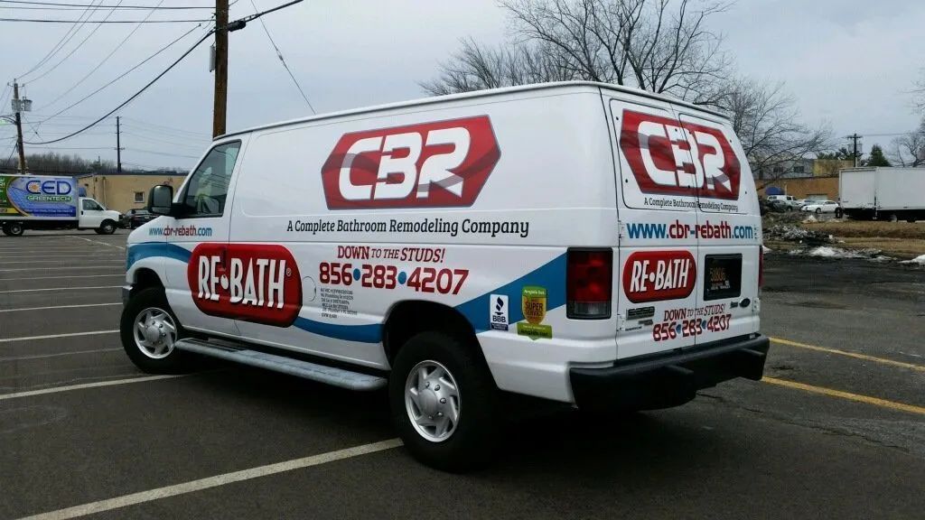 White CBR Bath service van parked in a lot, with large red logos and contact details on the side.