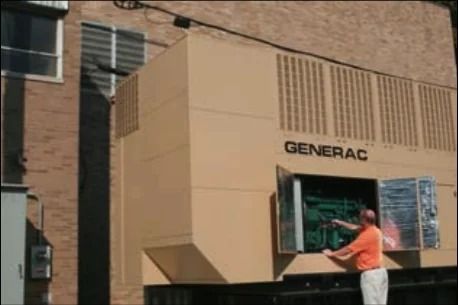 Person standing beside a large beige Generac generator mounted on a brick building