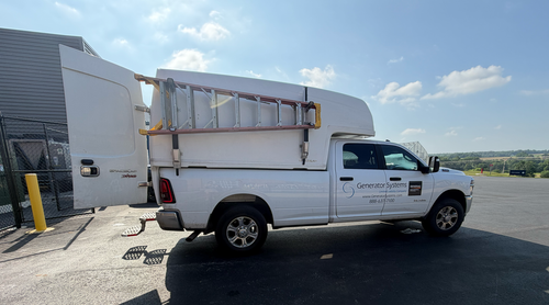 White utility truck with ladder rack parked outside a building, overlaid with “Always Ready” text.