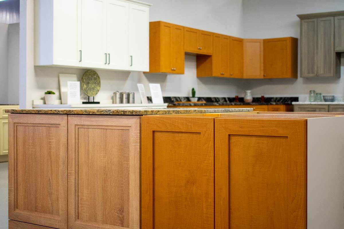 A kitchen with wooden cabinets and a granite counter top.