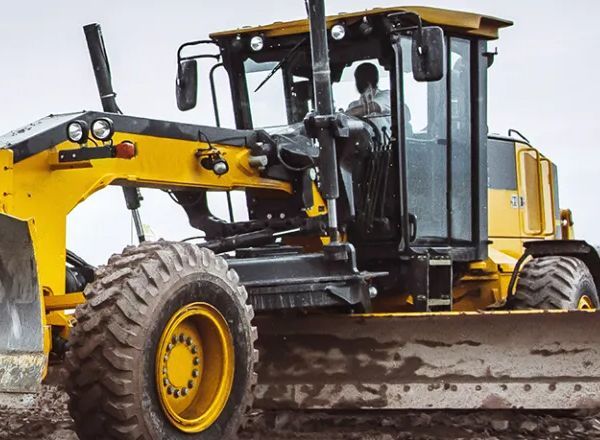 A yellow bulldozer is sitting in the dirt on a construction site.