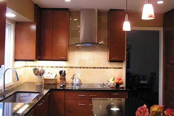 A kitchen with stainless steel appliances and wooden cabinets