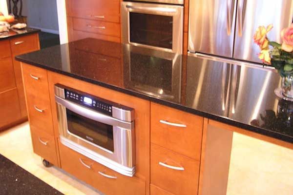 A kitchen with stainless steel appliances and wooden cabinets