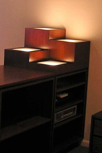 A wooden shelf with a few lights on it
