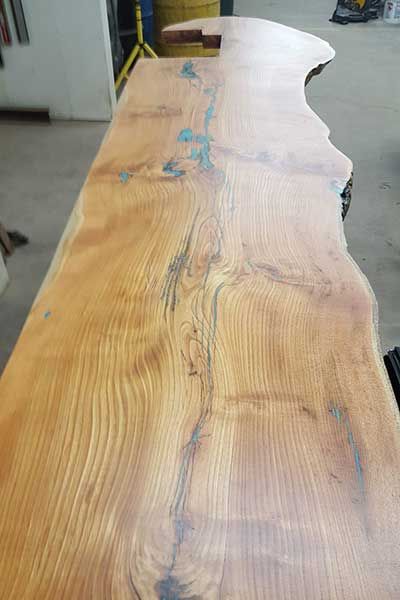 A large piece of wood is sitting on a table in a room.